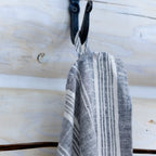 heather grey flax linen hand towel hanging from hook.