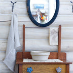 light natural frayed edge flax linen hand towel hanging from metal hook in log house